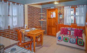 a kitchen with a table and a dining room at Cabaña LOW COST in El Bolsón
