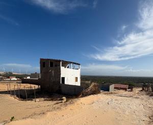 a building sitting in the middle of a desert at Por Do Sol Residence in Canoa Quebrada +20 photos