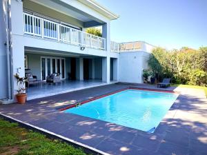 a swimming pool in the backyard of a house at Gemmel Place Villa in Durban