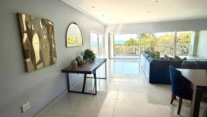 a living room with a couch and a table at Gemmel Place Villa in Durban