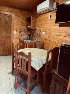 a kitchen with a table and chairs in a room at Cabañas El Zonda in Tinogasta