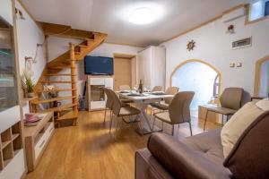 a living room with a table and chairs and a staircase at Villa Sea Valley in Crikvenica