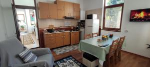 a kitchen with a table and a kitchen with a refrigerator at Little Bear Busteni 3 in Buşteni