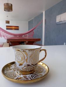 a coffee cup on a plate on a table at Pousada Paraíso das Dunas in Bitupitá +21 photos