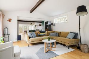 a living room with a couch and a table at Modern family home next to Mälaren in Mariefred in Mariefred