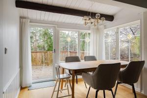 a dining room with a wooden table and chairs at Modern family home next to Mälaren in Mariefred in Mariefred