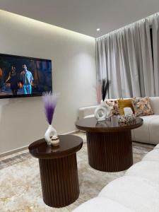 a living room with two tables and a couch at Apartment City Center Hilton Tanger in Tangier