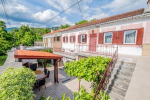 an outdoor patio with a table and chairs and a building at Villa Sea Valley in Crikvenica