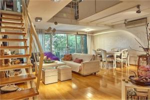 a living room with a couch and a table at Departamento Paraiso in Eva Perón