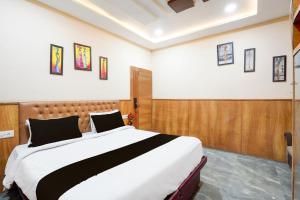 a bedroom with a large bed in a room at Hotel O The Indian Spices in Rao