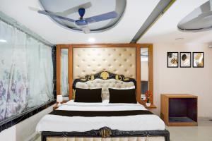 a bedroom with a bed and a ceiling fan at Hotel O The Indian Spices in Rao