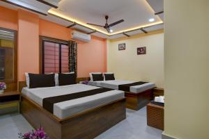 Postel nebo postele na pokoji v ubytování Collection O Asian Highway Near Agrasen Hospital Siliguri Formerly Ashiyana Homestay