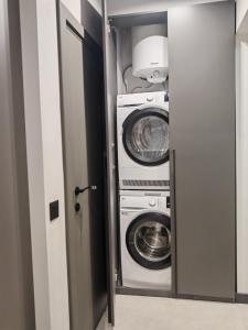 een wasruimte met 2 wasmachine en droger bij Апартамент Александровска in Boergas +4 foto's