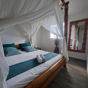 Postel nebo postele na pokoji v ubytování Oasis Grande Anse