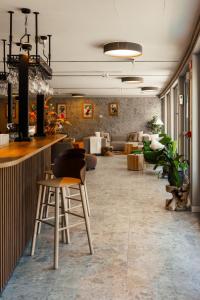 a lobby with a bar and chairs in a room at Maison Poluc - Petit Bijou in Champoluc
