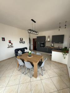 a living room with a wooden table and chairs at Panoramic Tower in Torre del Greco