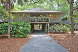 a large green house with a walkway leading to it at IC106: 106 Inlet Cove in Kiawah Island
