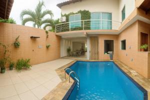 a house with a swimming pool in front of it at Pousada 218 in Manaus