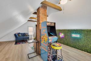 a living room with a video game and a chair at The Game House Arcade West Hartford in West Hartford