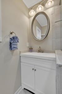 a white bathroom with a sink and a mirror at The Game House Arcade West Hartford in West Hartford +20 photos