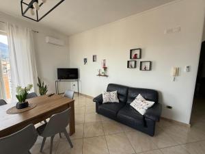a living room with a table and a couch at Panoramic Tower in Torre del Greco