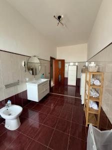 a bathroom with a toilet and a sink and a mirror at Panoramic Tower in Torre del Greco +14 photos