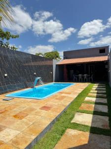 a swimming pool in the backyard of a house at Casa Paradise in Jijoca de Jericoacoara