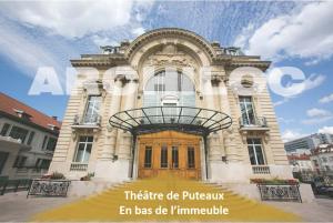 a building with a yellow door in front of it at L'incontournable de Paris la Défense in Puteaux
