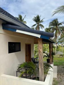 a house with a surfboard on the roof at The Ridge-Coconut Cottage in Buff Bay