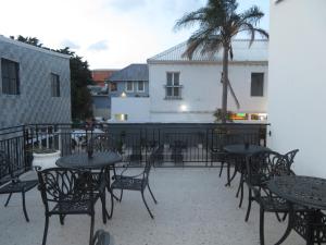 a group of tables and chairs on a patio at Eden Hotel on Florida in Durban