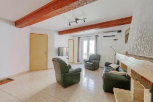 a living room with two chairs and a couch at Gîtes Tautavel in Tautavel