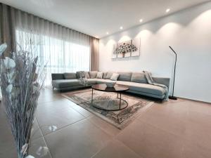 a living room with a couch and a table at Modern Oasis with Jacuzzi & Two Terraces in Palm-Mar