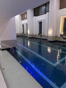 a lobby with a swimming pool in a building at White Domes Hotel in Baghdād