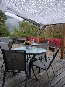 a table and chairs on a wooden deck at Weingut Harald Konrad Fehres in Brauneberg
