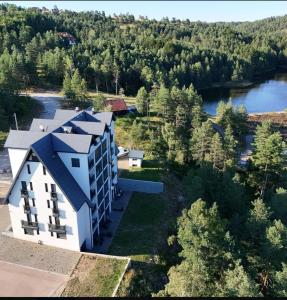 an aerial view of a building next to a lake at Apartment Ogi in Divčibare