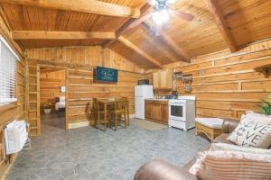 a living room with a couch and a kitchen in a cabin at Wooden Suite #6 in Madill +11 photos