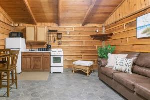 a living room with a couch and a kitchen at Wooden suite #7 in Madill