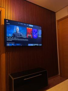 a flat screen tv on a wall in a room at Résidence BAB Sebta apartment Ghali in Fnidek