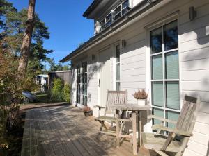 a patio with two chairs and a table at Enjoy nature in silence in Ljungen