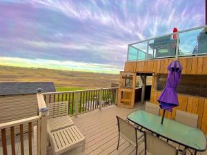 a balcony with a table and chairs on a deck at Covington Close in Calgary