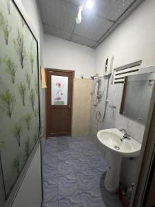 a bathroom with a sink and a toilet and a shower at David Villa in Anuradhapura