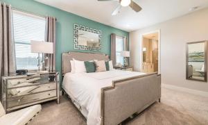 a bedroom with a bed and a green wall at Serene Vibrant 4 Bdrm Villa with Games Room at Encore in Orlando +21 photos