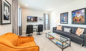 a living room with a couch and a table at Serene Vibrant 4 Bdrm Villa with Games Room at Encore in Orlando