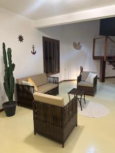 - un salon avec des canapés et un cactus dans l'établissement Pousada ViniCarmel Arraial d ajuda, à Arraial d'Ajuda