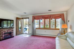 a living room with a couch and a fireplace at 2 Mi to APG Edgewood Family Home with Fenced Yard in Edgewood