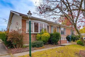 a house with a green street light in front of it at 2 Mi to APG Edgewood Family Home with Fenced Yard in Edgewood
