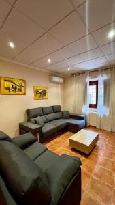 a living room with a couch and a table at La Casa Azul in Cehegín