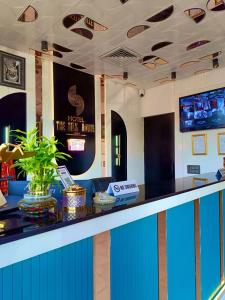 a lobby of a hotel with a blue and white counter at The Silk Route Hotel in Panchkula