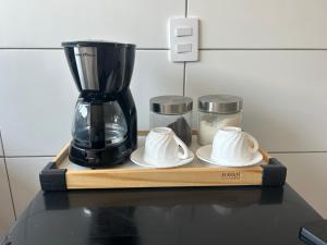 a black blender sitting on a table with some dishes at Casa 01 - Casa com 2 quartos, próximo a rodoviária e aeroporto in Palmas