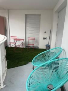 a table and four chairs and a table and chairs at Ins apartment - 2 bedrooms - metro parking prive in Bagnolet